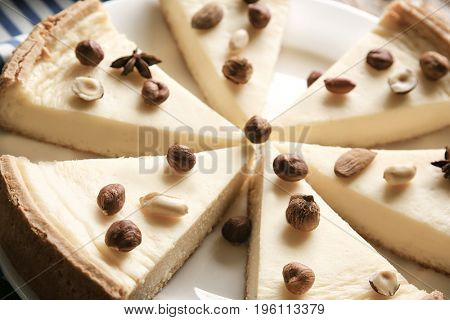 Delicious sliced cheesecake with nuts, closeup