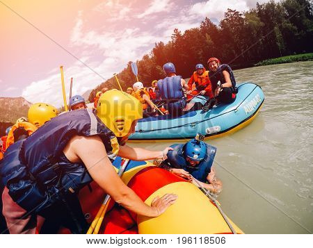 mountain Altai, RUSSIA - July 16, 2017: group of friends' friends sail on a boat in life jackets and helmets., rafting