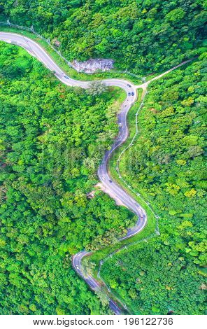 aerial viewTop viewamazing nature background.Winding road on the mountain.And the car ran.A beautiful view.thailand