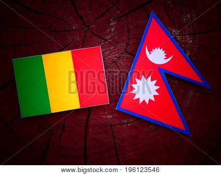 Malian Flag With Nepali Flag On A Tree Stump Isolated