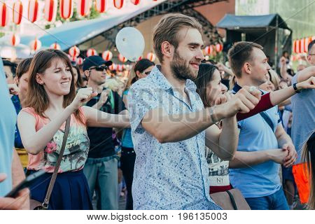 Moscow Russia - April 24 2016: People dancing around the stage of the Yagura the dance of Bon Odori at the japanese festival.