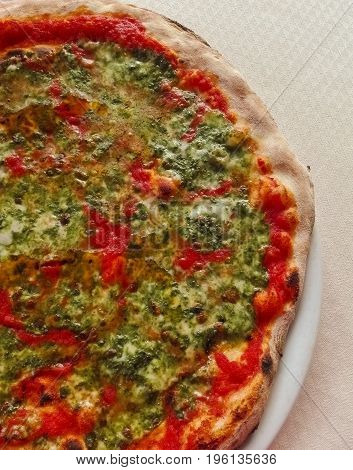 typical italian pizza with tomato and nettle vegetable