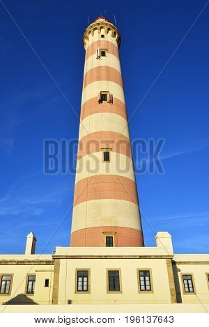 Beautiful view on the Lighthouse Farol da Barra in Praia da Barra resort at sunset famous resort in Portugal