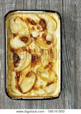 close up of rustic golden scalloped potato gratin dauphinois
