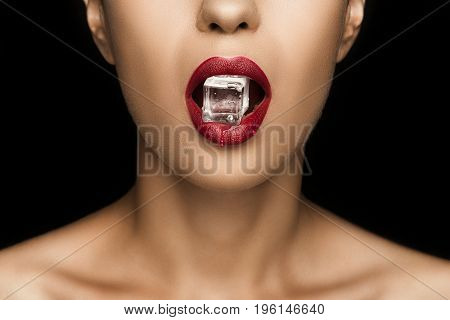 Cropped View Of Seductive Woman With Red Lips Holding Ice Cube In Mouth, Isolated On Black
