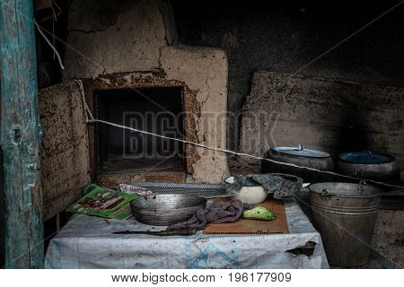 Kettles and frying-pans near a village oven