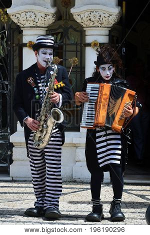 Aveiro Portugal - June 10 2017: Street musicians perform a show on the street in Aveiro. Aveiro is one of the most popular tourist cities in Portugal