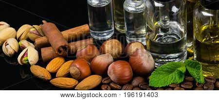 Flavored liquids in bubbles surrounded by nuts cinnamon and fresh mint
