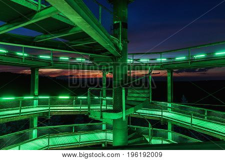 Treetop Walkway lignting Sightseeing trail in tree crowns. Wooden construction with a slide in the middle. Touristic place and unique constructionc. Treetop Walkway in Lipno Czech Republic