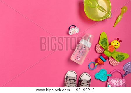 Baby toys and accessories on pink background. Top view. Copy space. Still life. Flat lay