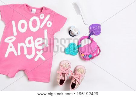 Baby clothes and accessories on white background. Top view. Copy space. Still life. Flat lay