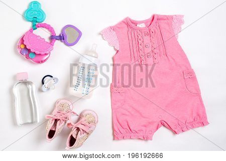 Baby clothes and accessories on white background. Top view. Copy space. Still life. Flat lay