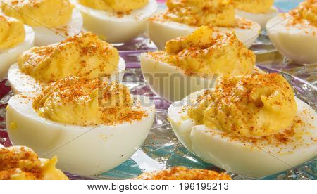 Several delicious Deviled Eggs topped with paprika