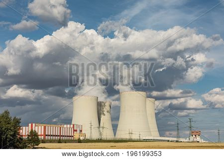 Nuclear power plant Temelin in the Czech Republic. Dusk landscape with big chimneys. Clouds of steam derailing from a nuclear power station tower.