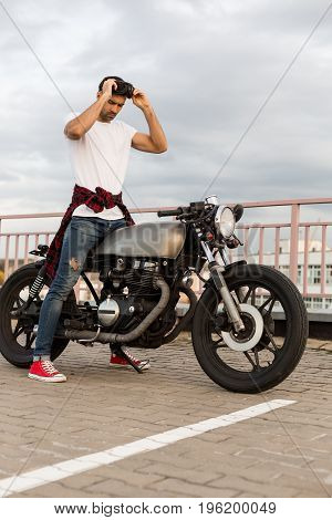 Brutal Man Near His Cafe Racer Custom Motorbike.