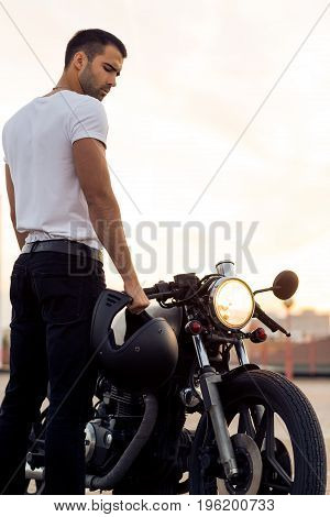 Brutal Man Near His Cafe Racer Custom Motorbike.