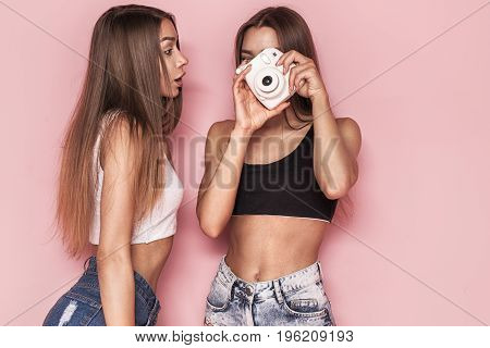 Young Twins Sisters Taking Photos.