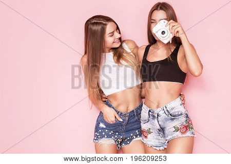 Young Twins Sisters Taking Photos.