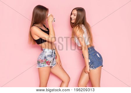 Young Twins Sisters Taking Photos.
