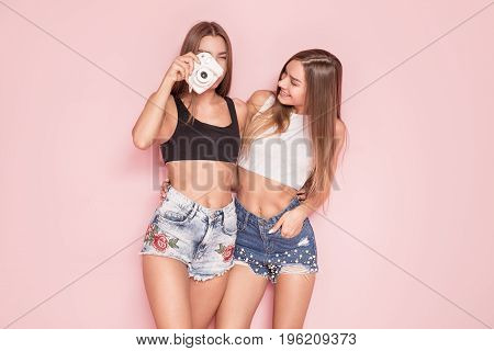 Young Twins Sisters Taking Photos.