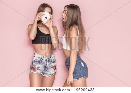 Young Twins Sisters Taking Photos.