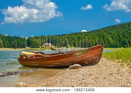 Boat on the coast of Black Lake (Crno jezero) in Durmitor National Park Montenegro