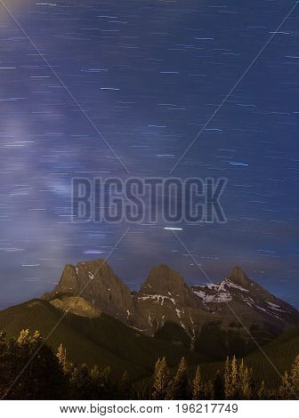 Star Trails and the Milky Way Over the Three Sisters Mountain Range, Canmore, Alberta, Canada