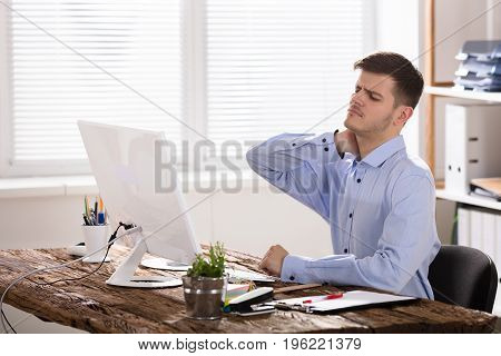 Businessman Suffering From Neck Ache Touching His Neck In Pain