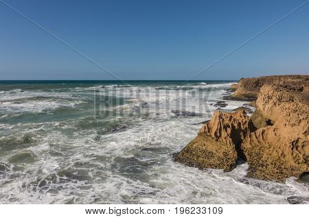 Waves  Breaking Of Cliffs Near Oualidia Lagoon In Same Name Village In Atlantic Ocean Coast, Morocco