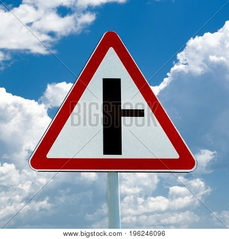 Road sign t-intersection on a background of blue sky