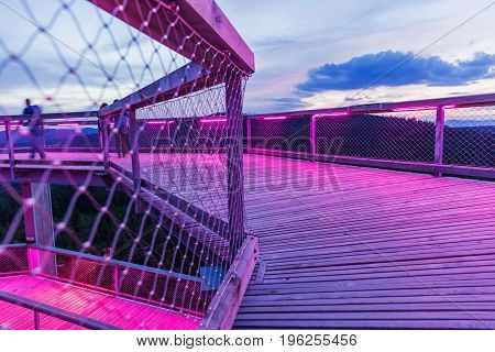 Treetop Walkway lignting Sightseeing trail in tree crowns. Wooden construction with a slide in the middle. Touristic place and unique constructionc. Treetop Walkway in Lipno Czech Republic