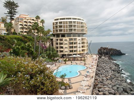 FUNCHAL PORTUGAL - SEPTEMBER 3 2016: Swimming pool with tourists at Lido hotels zone in Funchal Madeira island Portugal