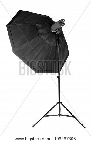 A modern electric saturated black octobox on a tripod. A huge octobox isolated over the white background. Equipment for photogrphers. Professional shooting in a photostudio.