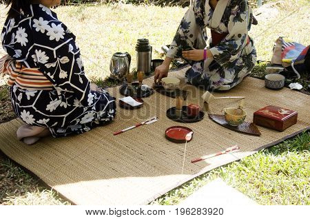 Japanese Women Making Sado Chanoyu Or Japanese Tea Ceremony, Also Called The Way Of Tea At Outdoor