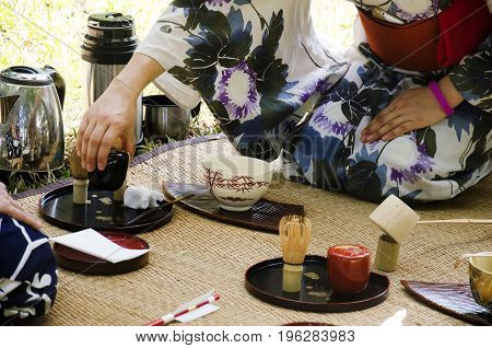 Japanese Women Making Sado Chanoyu Or Japanese Tea Ceremony, Also Called The Way Of Tea At Outdoor