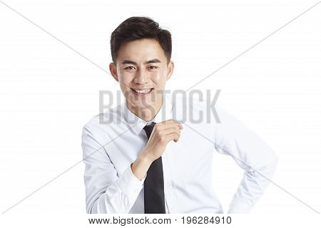 studio portrait of a young asian businessman wearing shirt and tie happy and smiling isolated on white background.