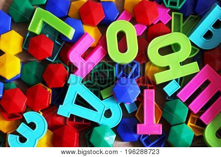 A background made from multicolored, cut ut magazine letters pasted to a board with random