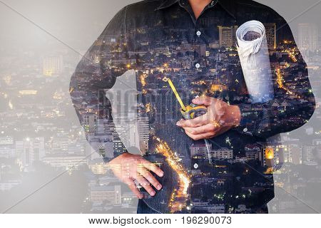 Double Exposure Of City And Engineering Holding Tape Measure And Blueprint