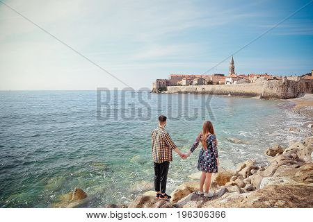 Young couple at the seaside holding hands