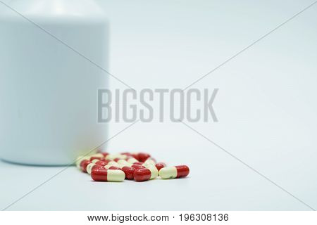 Capsule pills with bottle on white background