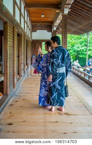 KYOTO, JAPAN - JULY 05, 2017: Unidentified couple taking pictures of the Hojo Hall of Tenryu-ji in the Arashiyama district of Kyoto, Japan.
