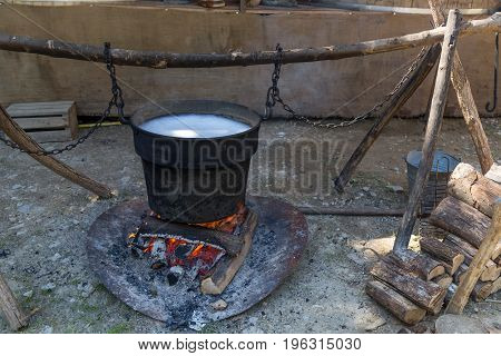 Medieval campfire with iron pot caudron and fire.