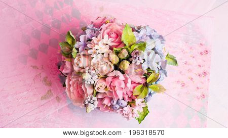 a bouquet of flowers on a pink background in style shabby chic.