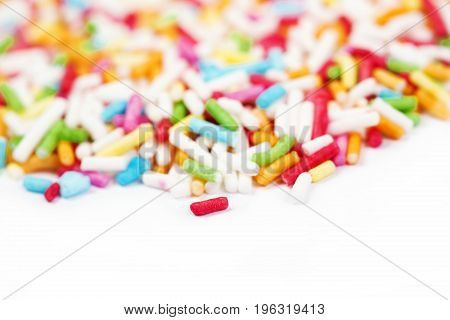Sugar sprinkle dots decoration for cake and bekery a lot of sprinkles as a background. Wiith copyspace