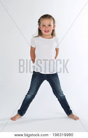 Cute blonde little girl barefoot white background