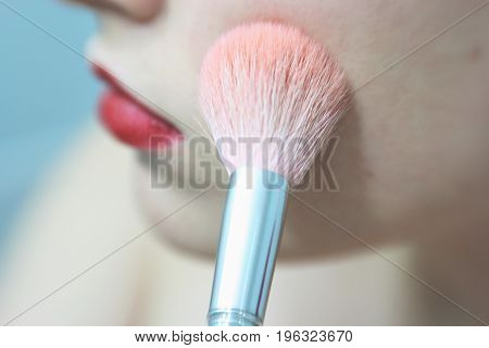 Make Up Vanity 2: self portrait of a woman applying makeup, shallow depth of field draws attention to pink brush