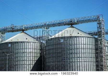 Industrial storage of raw materials in silos. Granary in the open sky.