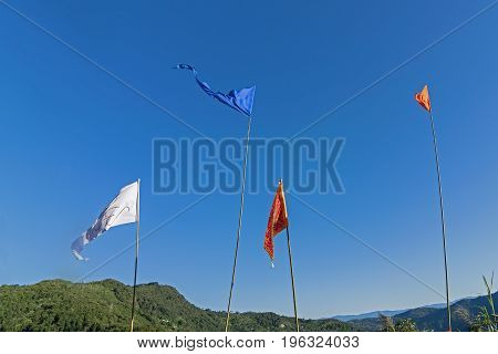 Colurful Buddhist Prayer flags are waving in strong wind under sunshine at Samdruptse huge buddhist memorial Monastery in Sikkim India.