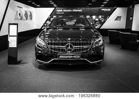 BERLIN - JANUARY 24 2015: Showroom. Mid-size luxury car Mercedes-Benz CLS 63 AMG. Black and white. Produced since 2013.