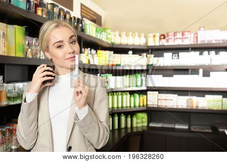 Beautiful young woman in perfumery